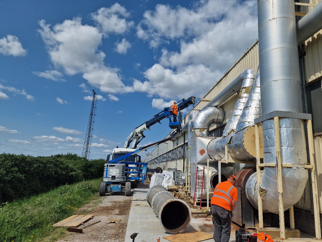 Container being positioned on site with a truck-mounted crane
